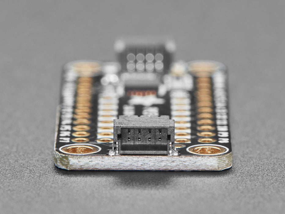 Overhead video of a GPIO expander breakout wired to two LEDs and a microcontroller on a breadboard. A hand presses a button on the bottom of the GPIO expander, individually lighting up the yellow and blue LEDs. 