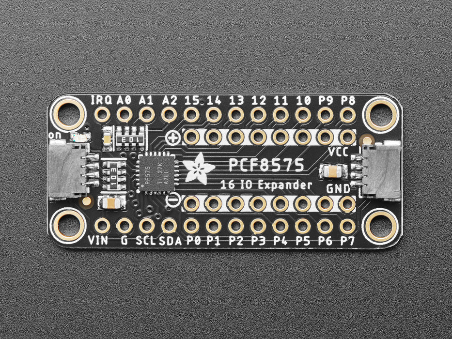 Overhead video of a GPIO expander breakout wired to two LEDs and a microcontroller on a breadboard. A hand presses a button on the bottom of the GPIO expander, individually lighting up the yellow and blue LEDs. 