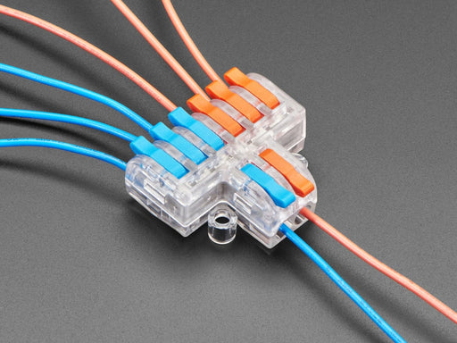 Angled shot of clear 2-to-6 Wiring Block Connector assembled with blue and red wires.