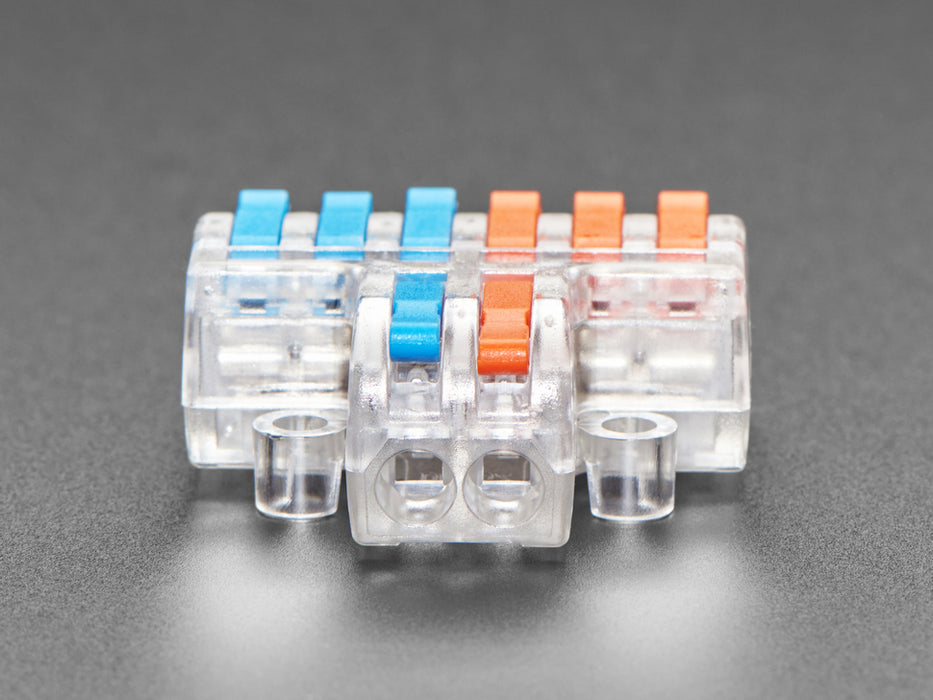 Angled shot of clear 2-to-6 Wiring Block Connector assembled with blue and red wires.