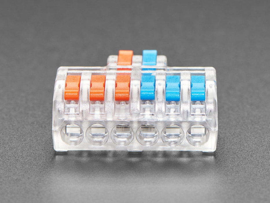 Angled shot of clear 2-to-6 Wiring Block Connector assembled with blue and red wires.