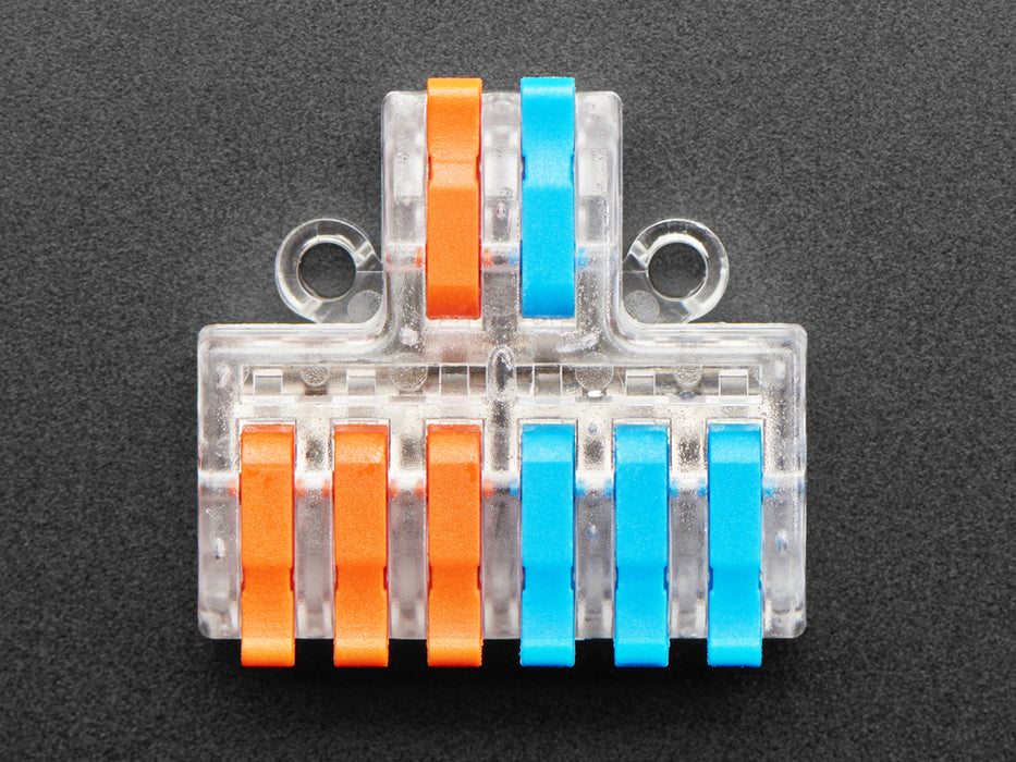 Angled shot of clear 2-to-6 Wiring Block Connector assembled with blue and red wires.