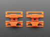 Angled shot of two orange plastic buckles assembled with two different wiring block connectors.