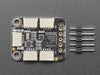 Angled shot of black, square 4-channel multiplexer with five tan STEMMA QT connectors.