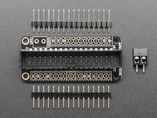 Angled shot of a black rectangular microcontroller with GPIO header.