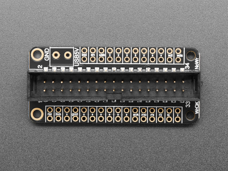 Angled shot of a black rectangular microcontroller with GPIO header.