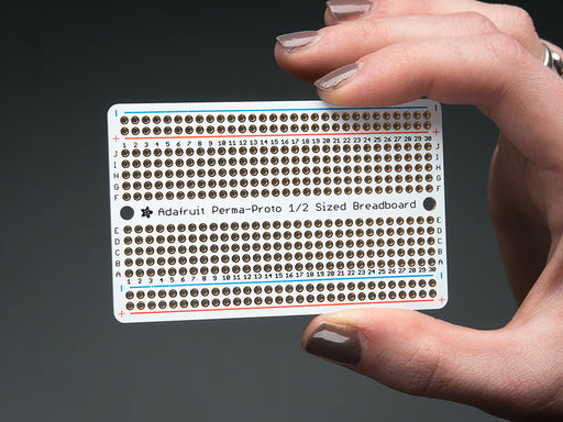 Top view of three fanned out Adafruit Perma-Proto Half-sized Breadboard PCBs.