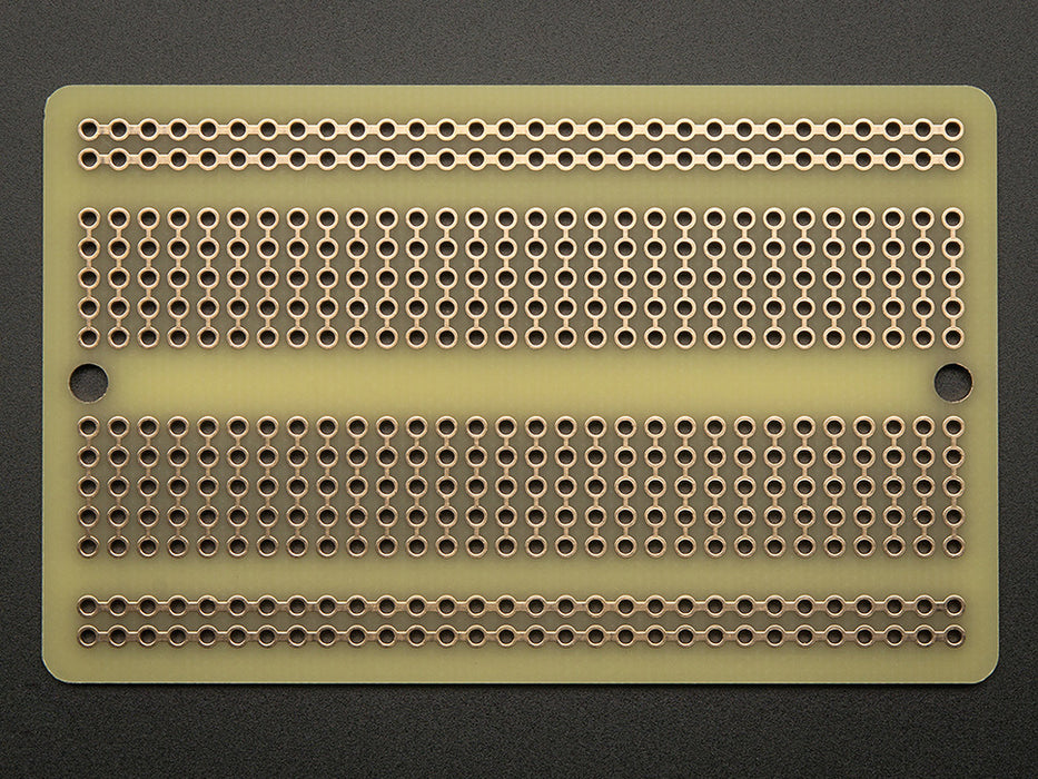 Top view of three fanned out Adafruit Perma-Proto Half-sized Breadboard PCBs.