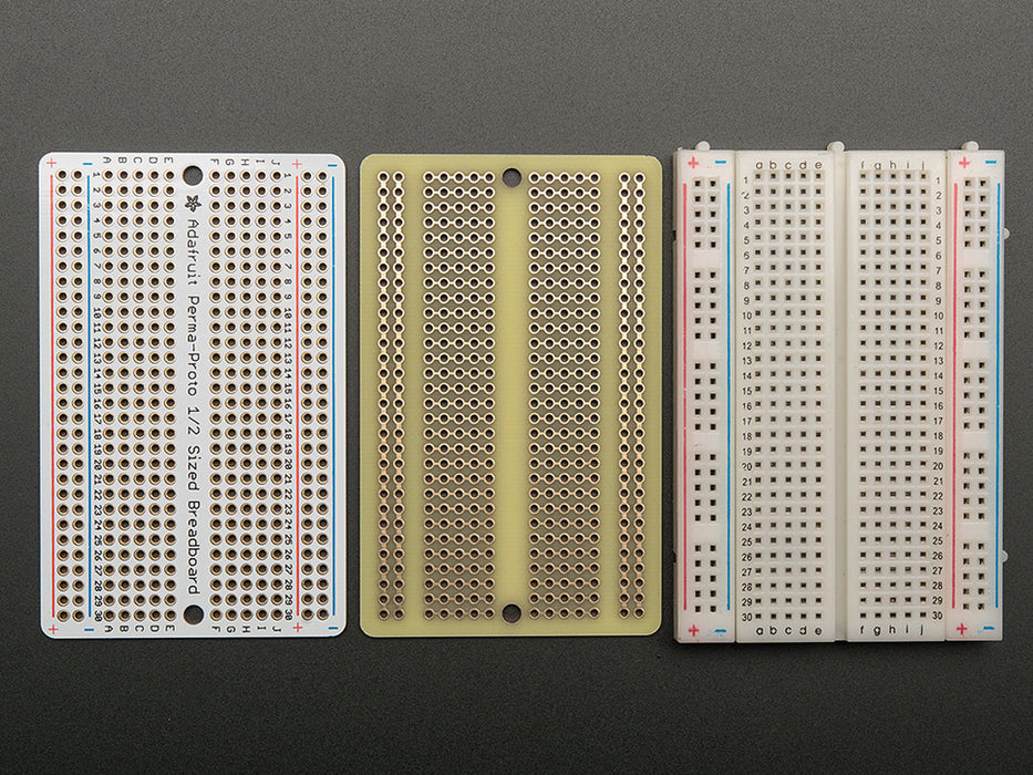 Top view of three fanned out Adafruit Perma-Proto Half-sized Breadboard PCBs.