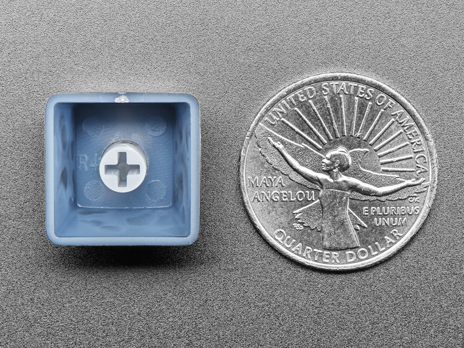 Overhead video of a chonky USB cable adapter with a black keycap. The keycap is etched with the Tumblr logo and glows blue.