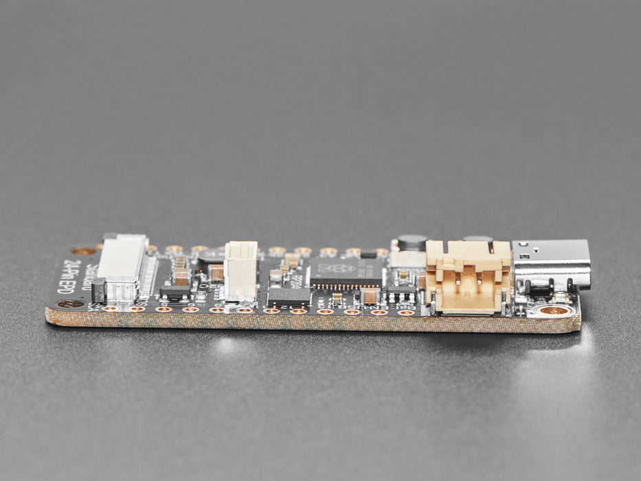 Overhead video of a rectangular microcontroller powering a big e-ink display.