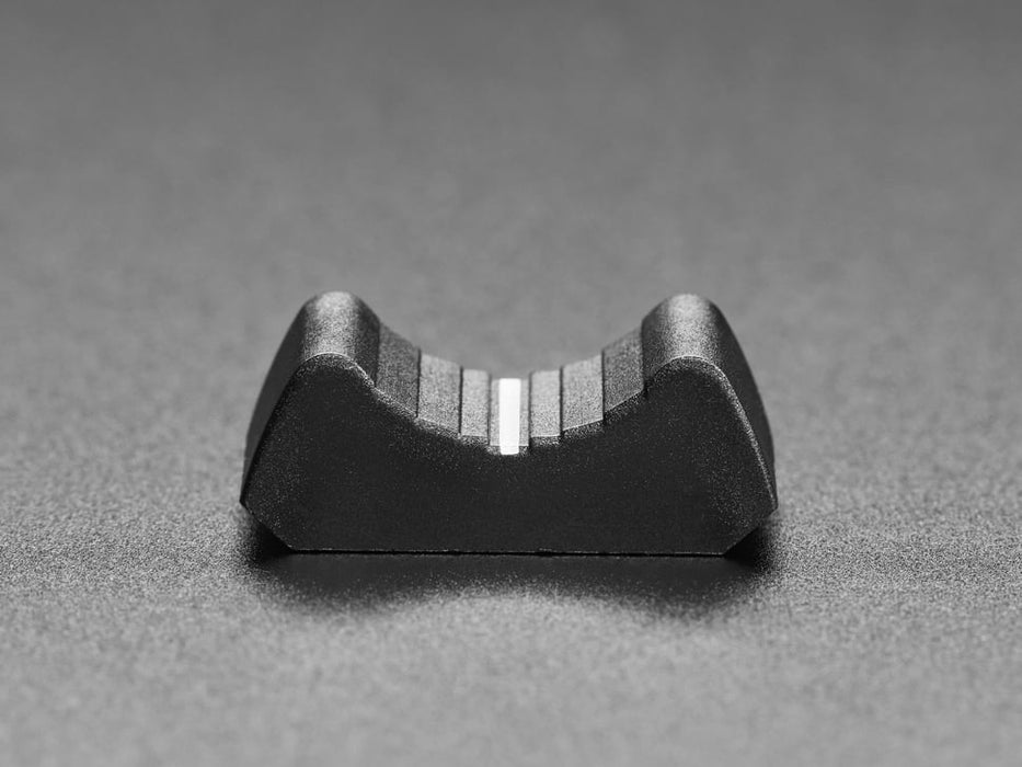 Angled shot of black plastic nubbin on a motorized slide potentiometer.