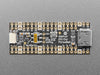 DVI breakout board assembled to a microcontroller in front of a small HDMI monitor. The display shows a flying toasters screensaver.