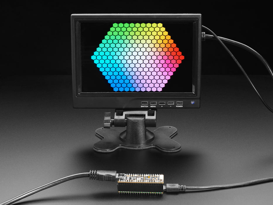 DVI breakout board assembled to a microcontroller in front of a small HDMI monitor. The display shows a flying toasters screensaver.