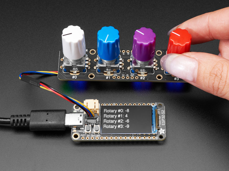 Video of a hand twisting the four encoder knobs with a data readout on a TFT microcontroller.