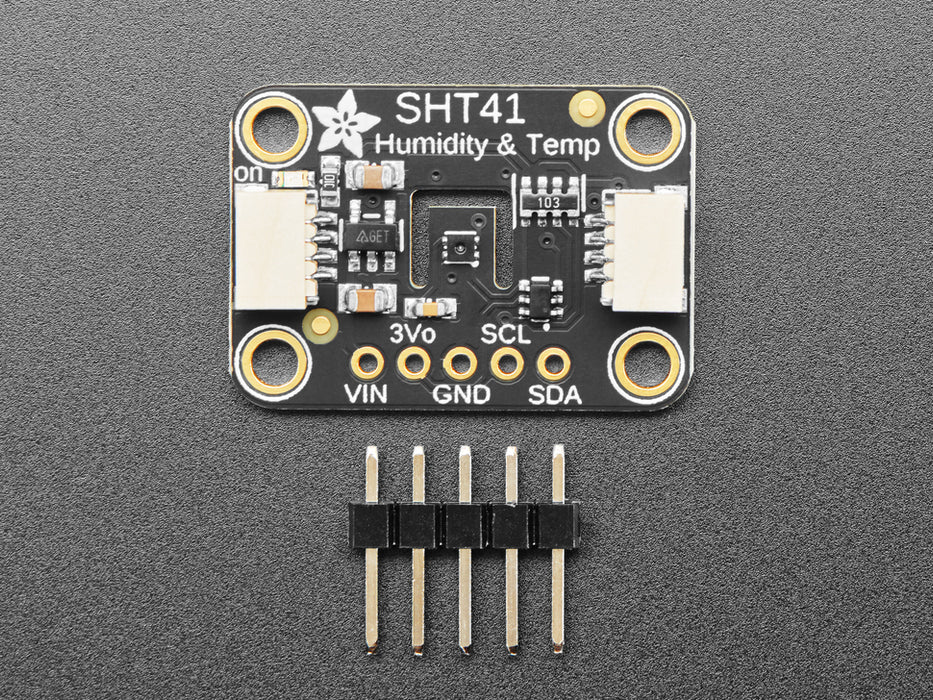 Overhead shot of humidity / temperature sensor breakout connected to an OLD screen, which displays the ambient temperature and humidity.