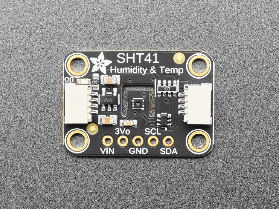 Overhead shot of humidity / temperature sensor breakout connected to an OLD screen, which displays the ambient temperature and humidity.