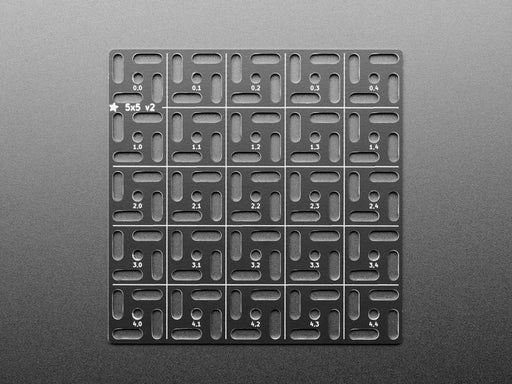 Overhead shot of 5x5 aluminum prototyping grid populated with a microcontroller and two breakout boards.