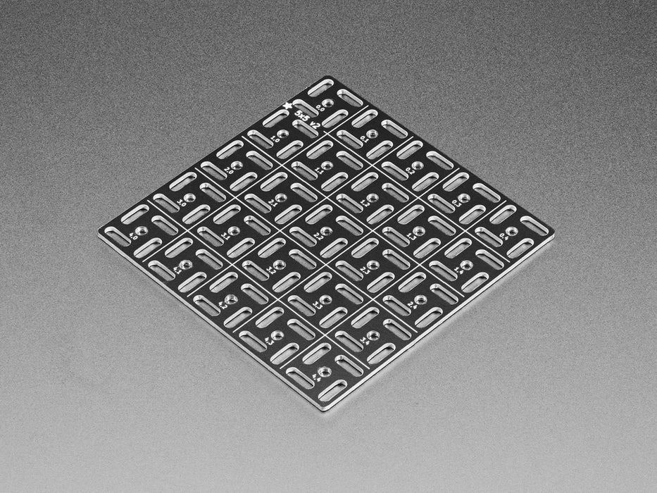 Overhead shot of 5x5 aluminum prototyping grid populated with a microcontroller and two breakout boards.