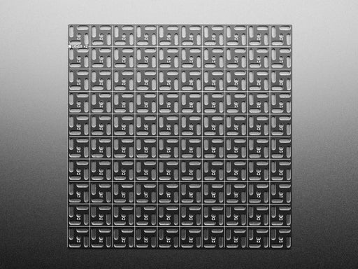 Overhead shot of 10x10 aluminum prototyping grid with a microcontroller and three breakout boards.