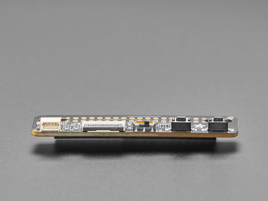 Overhead shot of long, black, slim add-on board installed on a Raspberry Pi computer and cabled to a sensor board and an electronic ink display.