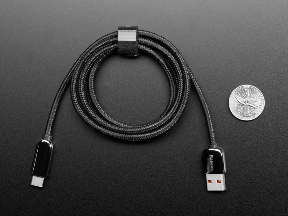 Angled shot of coiled black woven USB A to USB C cable.