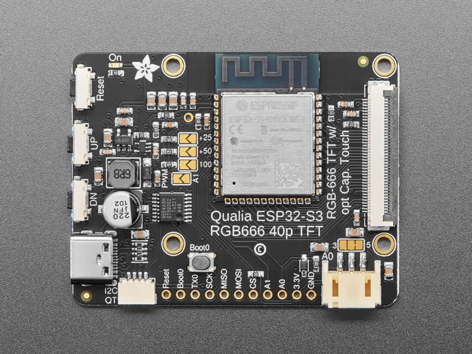 Overhead shot of TFT driver board connected to a round TFT display, which says, "Hello world!"