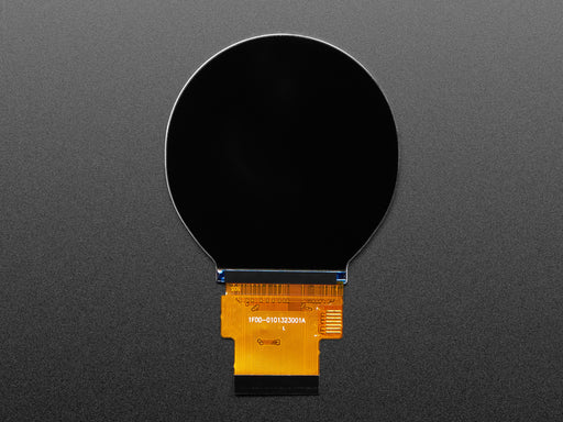 Overhead shot of round TFT display connected to a black, rectangular microcontroller. The TFT displays a rainbow color gradient.
