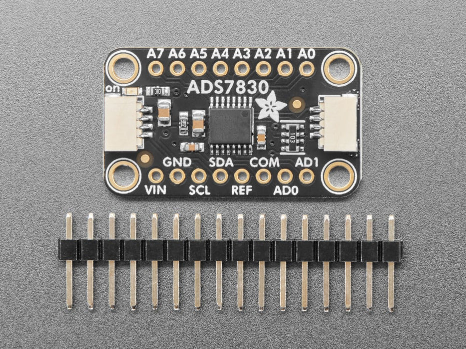 Angled shot of black, rectangular ADC breakout board.