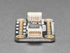 Angled shot of black, rectangular ADC breakout board.