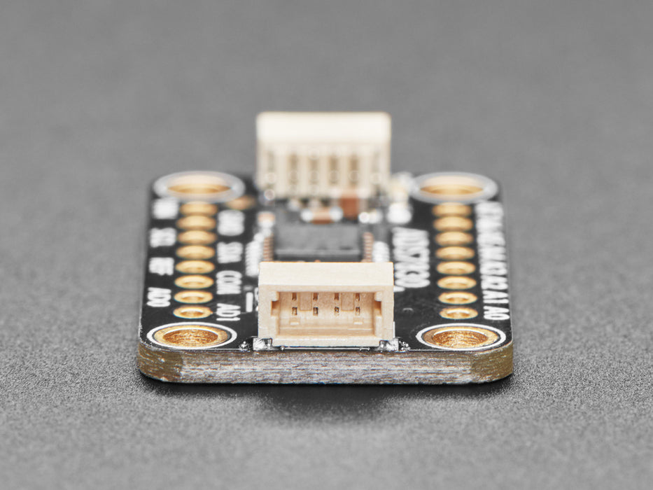 Angled shot of black, rectangular ADC breakout board.