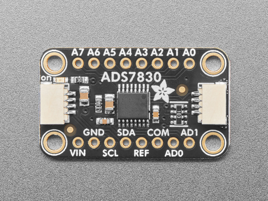 Angled shot of black, rectangular ADC breakout board.