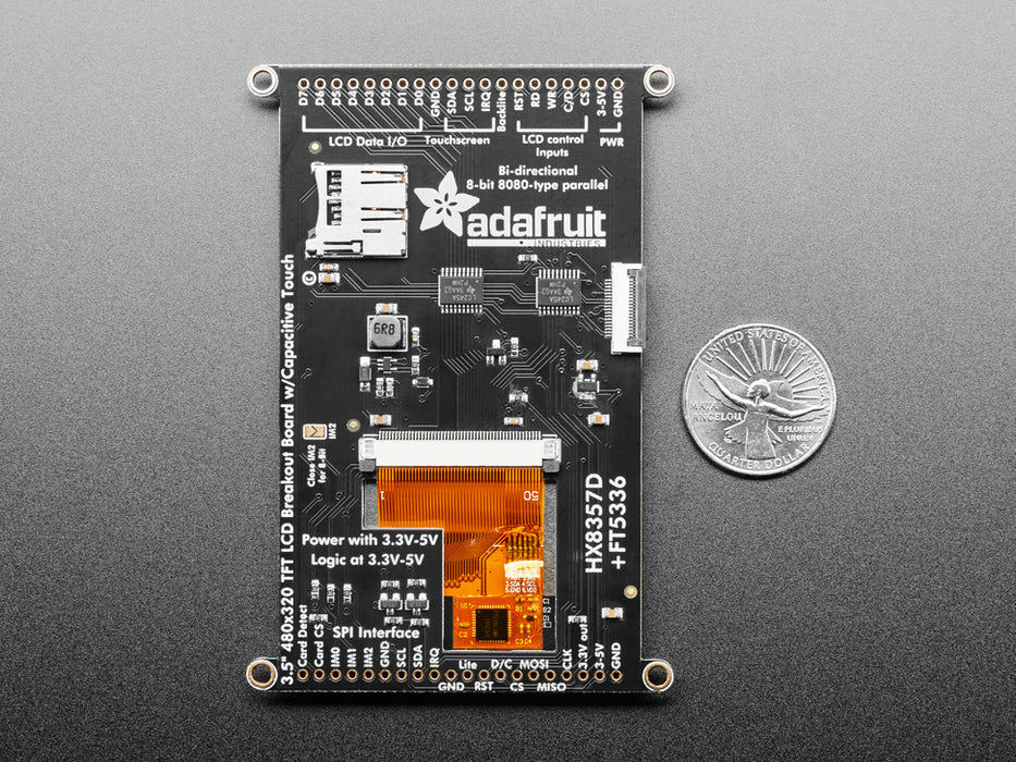 Overhead shot of a Black woman's green-manicured hand touching a 3.5" TFT display breakout connected to a small, square-shaped microcontroller. The TFT screen displays a drawn red heart.