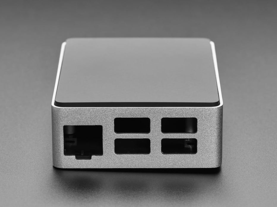 Angled shot of rectangular, aluminum microcontroller enclosure containing a Raspberry Pi computer.