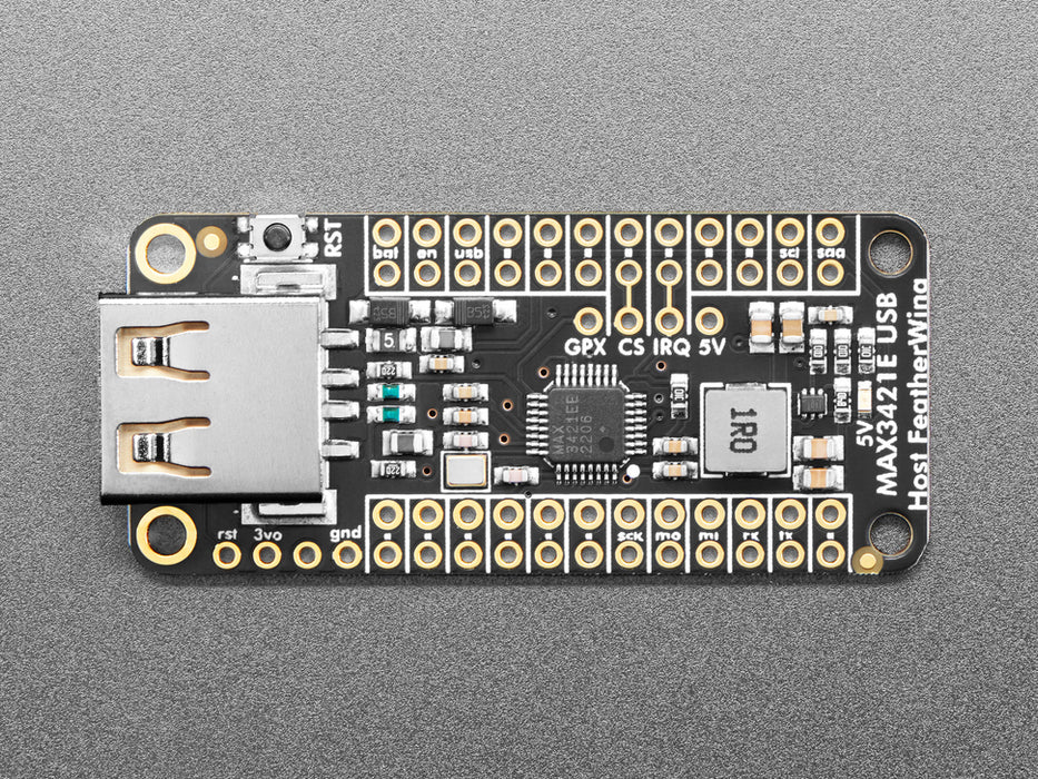 Video of a Black woman's green-manicured hand plugging in a USB TrinKey board into a USB Host FeatherWing assembled on a Doubler below an Adafruit TFT microcontroller board.