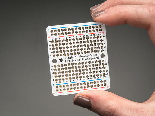 Top view of three fanned out Adafruit Perma-Proto Quarter-sized Breadboard PCBs.