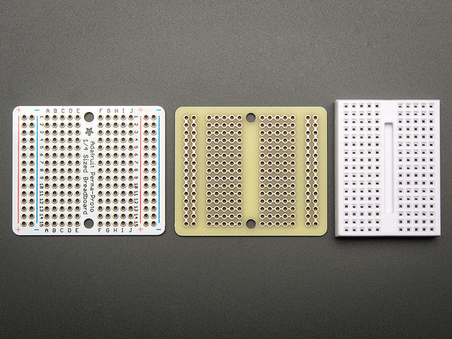 Top view of three fanned out Adafruit Perma-Proto Quarter-sized Breadboard PCBs.