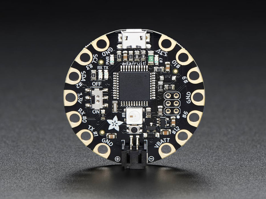 Top down view of a FLORA - Wearable electronic platform: Arduino-compatible connected to 4 alligator clips and a USB powerin the FLORA. 