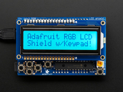 RGB LCD Shield Kit w/ 16x2 Character Display. Display backlight blue and reads "Adafruit RGB LCD Shield w/Keypad!"