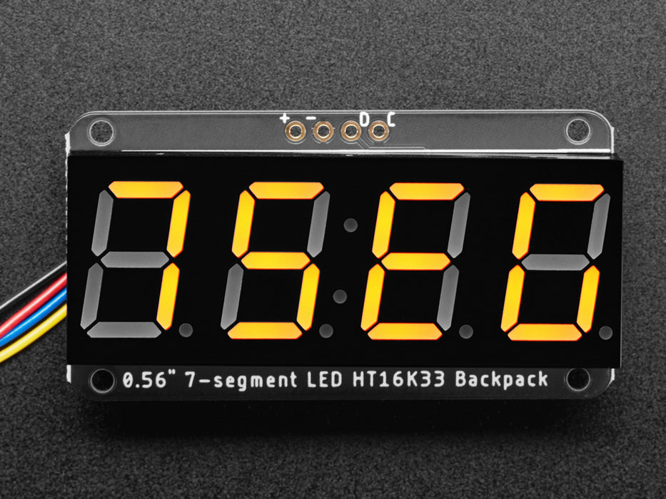 Yellow 7-segment clock display soldered to backpack with all segments lit