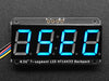 Blue 7-segment clock display soldered to backpack with all segments lit