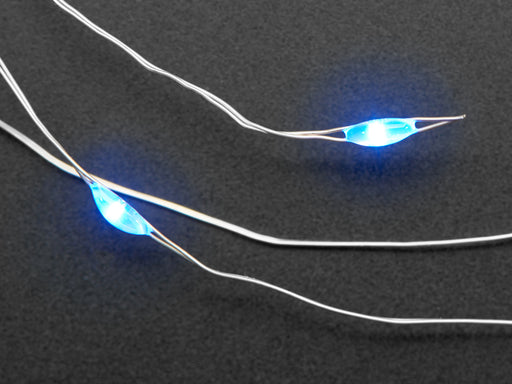 Coil of thin flexible wire with lit up embedded blue LED 'fairy' lights attached to battery holder